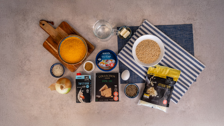 20 גרם חמאה ½ בצל קצוץ 2 כוסות פתיתים כוס וחצי מים חצי כוס שמנת מתוקה 100 גרם מוצרלה מגורדת 30 גרם פרמזן מגורדת מלח פלפל שחור קורט אגוז מוסקט בייבי מוצרלה של פיראוס ביצה אחת פירורי לחם שמן לטיגון רוטב רוזה או רוטב עגבניות להגשה